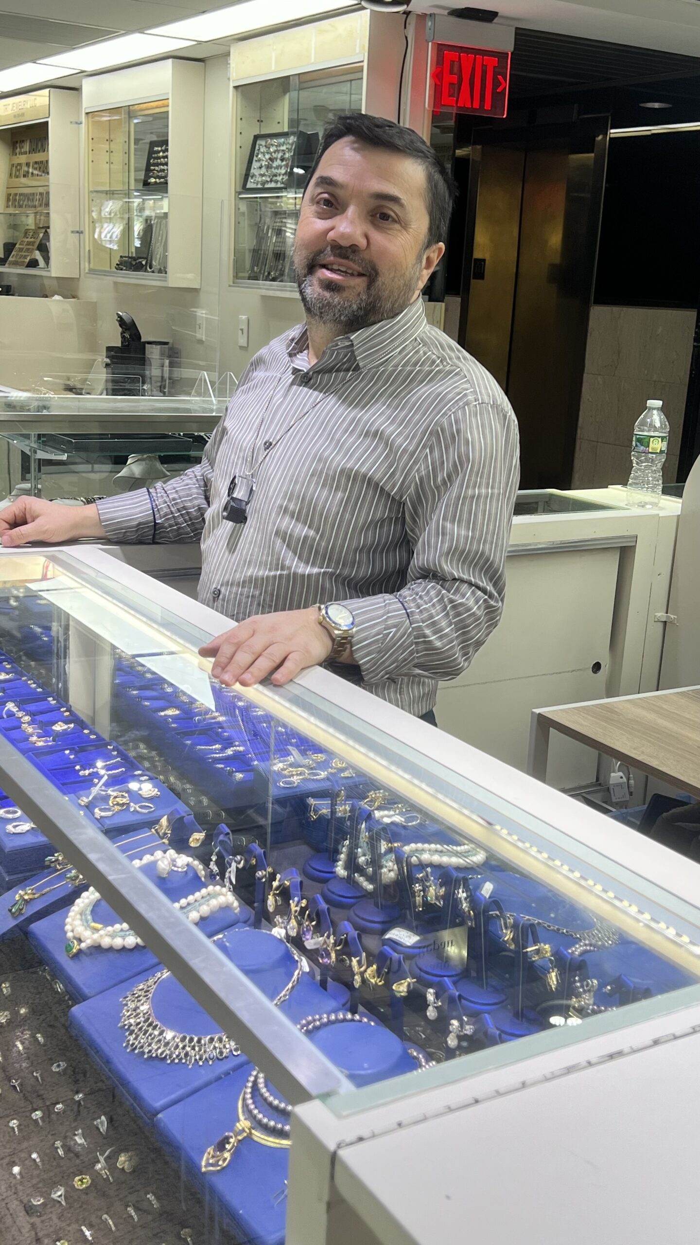 A jeweler's bench with hand tools and a loupe